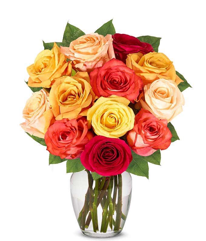 A stunning floral arrangement featuring orange roses, red roses, and yellow roses, optionally presented in a glass vase.