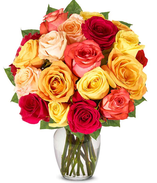  A stunning arrangement featuring one and a half dozen fall roses in vibrant autumn colors.